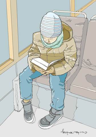 Boy reading book on train